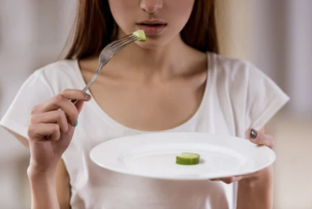 A woman holding a plate.