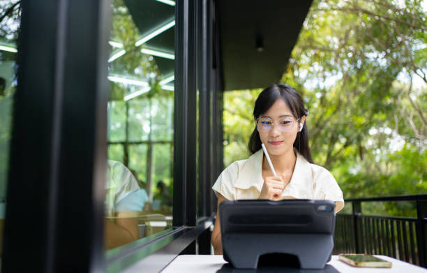 A woman using a laptop.