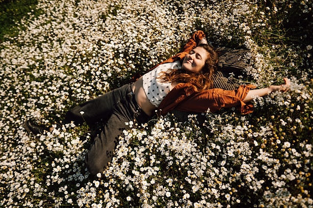A woman lying on a field of white flower