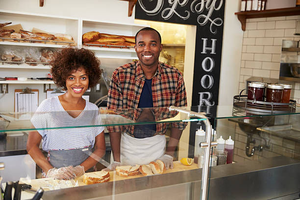 Black couple waiting behind the counter at a sandwich bar
