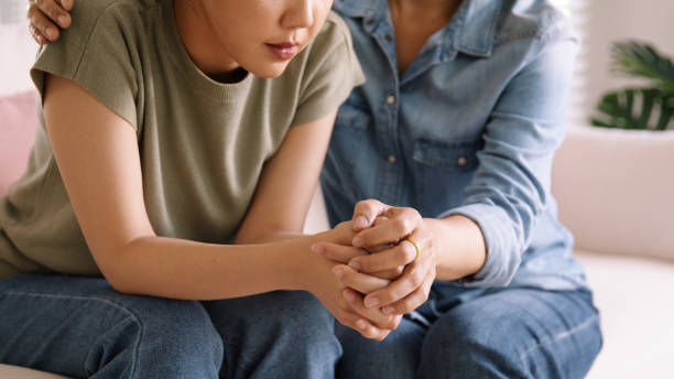 mom holding hands trust comfort help young woman