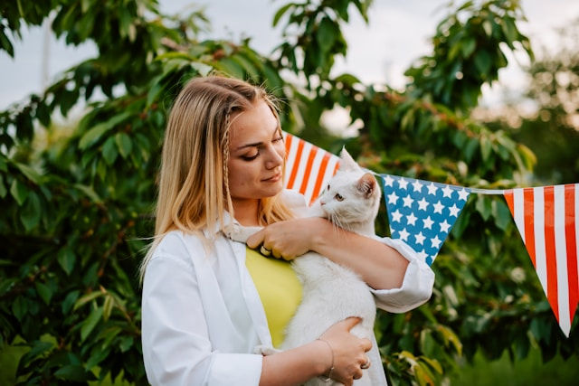 woman holding a white cat in her arms