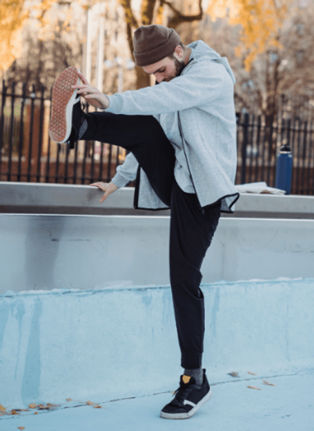 Man stretching in park on a nice morning weather