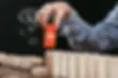 woman picking red block with word 'trends' out of wooden bricks,