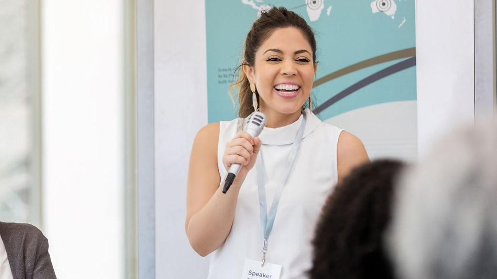 Happy woman speaking in front of people