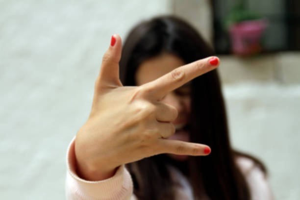 woman doing rockstar hand sign