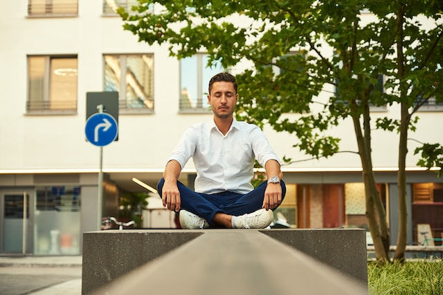 Young business man meditating during lunch break