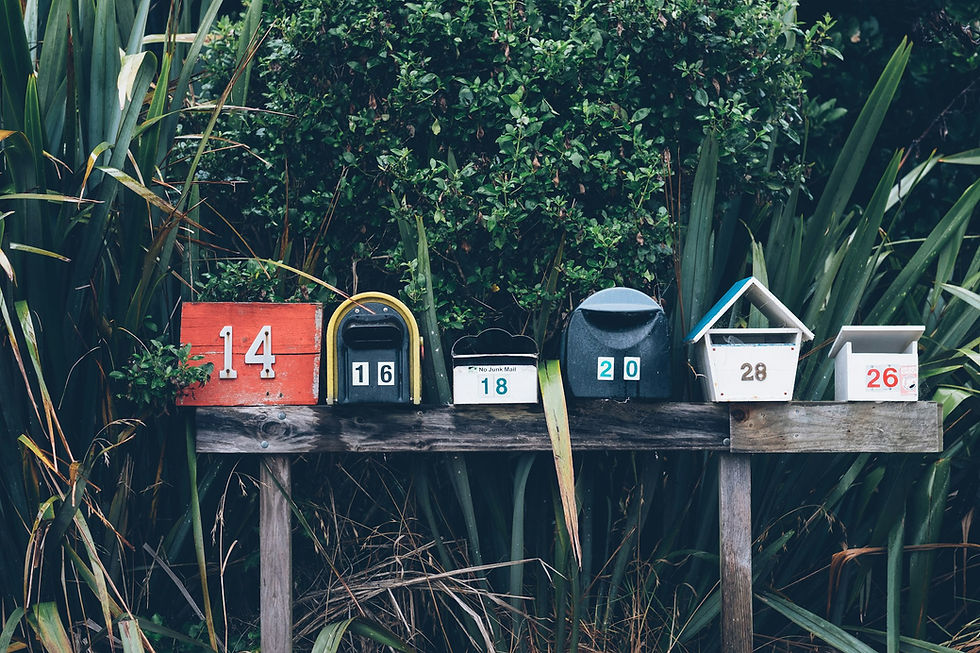 Six separate mailboxes in a row, one for each household