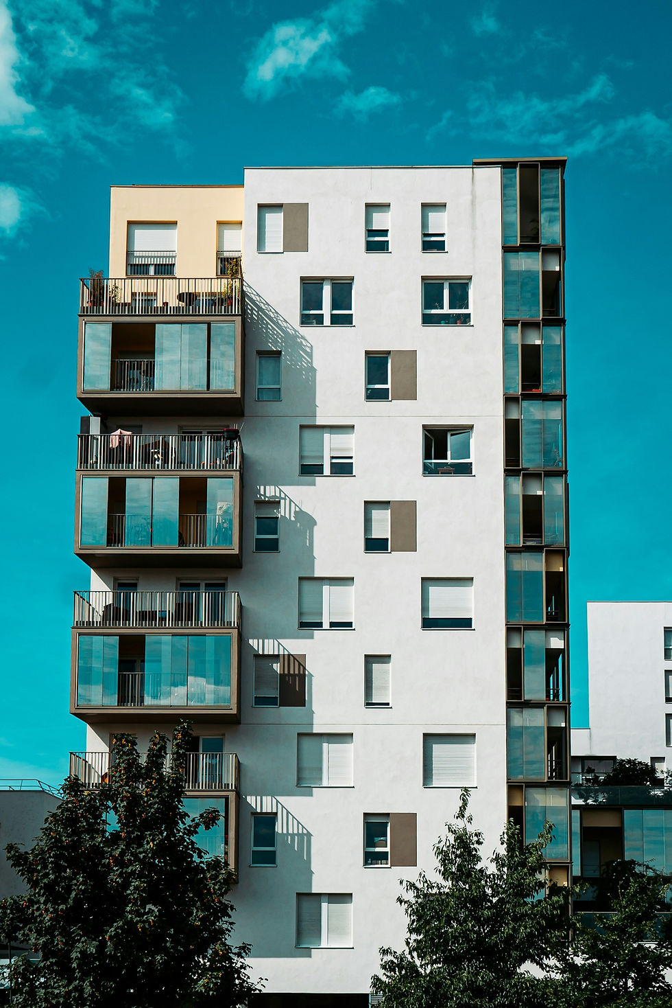 White high-rise residential building in Paris with many separate balconies