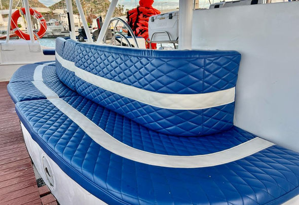 Blue quilted seating on a private catamaran tour in Cabo.