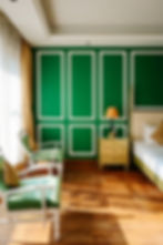 luxury hotel bedroom with green walls