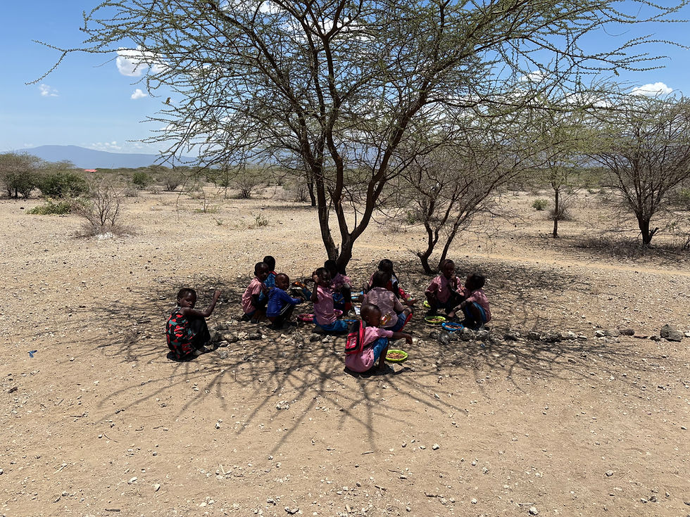 Young children gathered under a tree in Kenya.