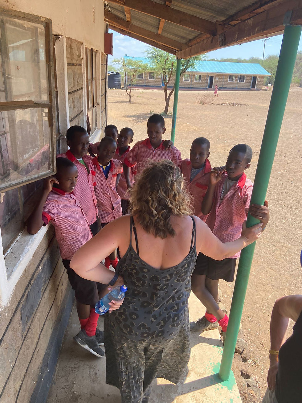 Woman volunteer talking to students in Kenya