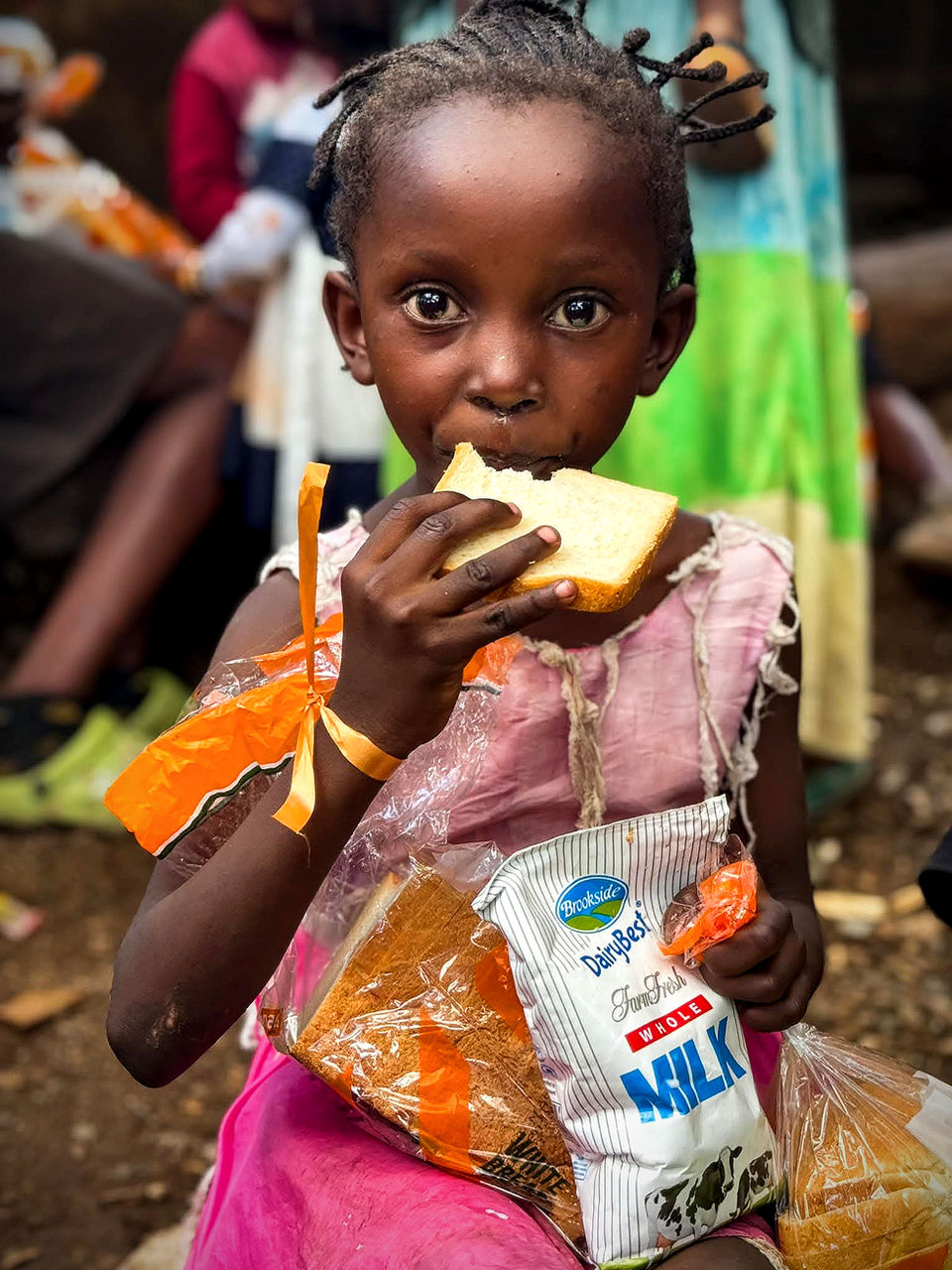 A street-connected girl eating bread as part of the See the Child programme, Nairobi.