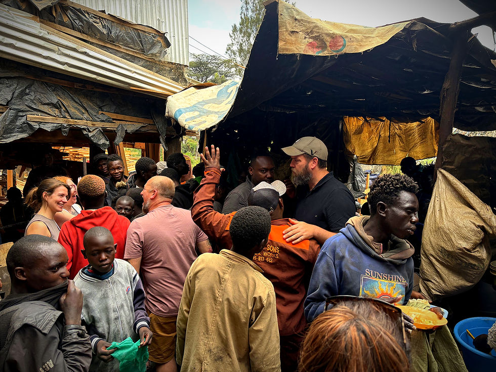People in a crowded outdoor setting, with volunteers engaging with the community