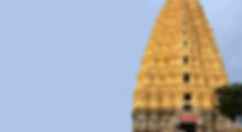 Ancient South Indian temple gopuram with intricate carvings, representing the sacred source of raw Indian temple hair used by Genius Hairs