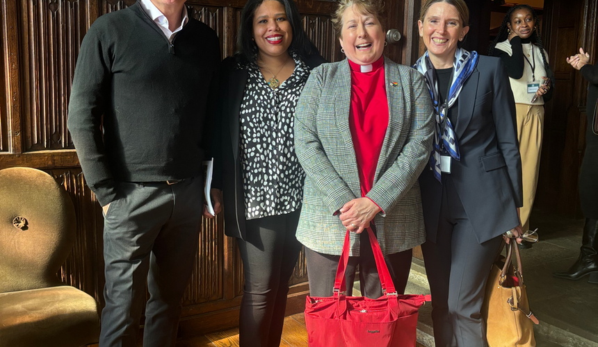Group of five attendees posing together in Foundation House's wood-paneled room during Food Security for Fairfield County gathering
