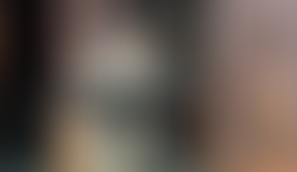 Speaker presenting at a podium near a barn door entrance at Foundation House.