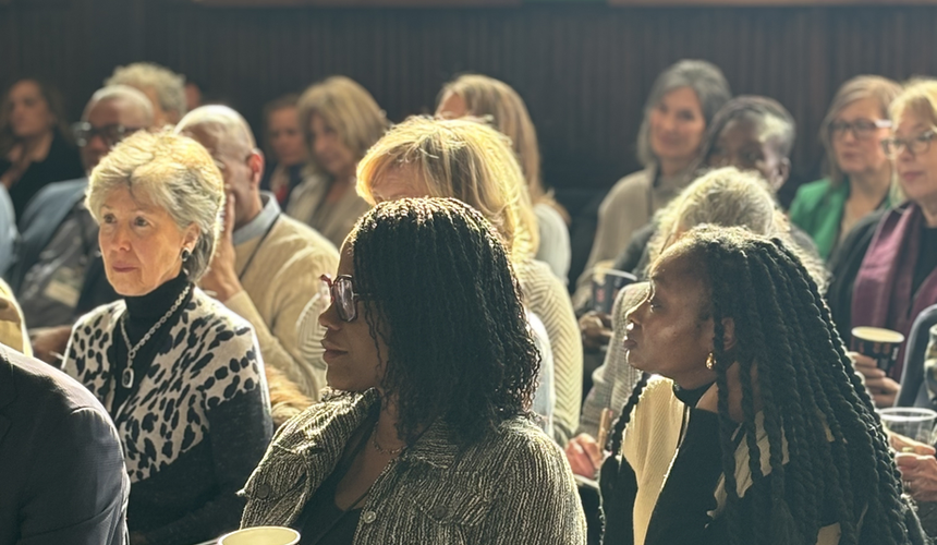 Attendees gathered in Foundation House's main room with ornate architectural details visible in the background.