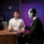 Firefly create an image with a person sitting in front of the laptop and a humanoid robot