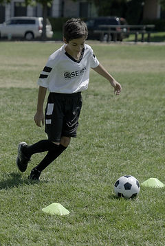 Boy dribbling soccer ball