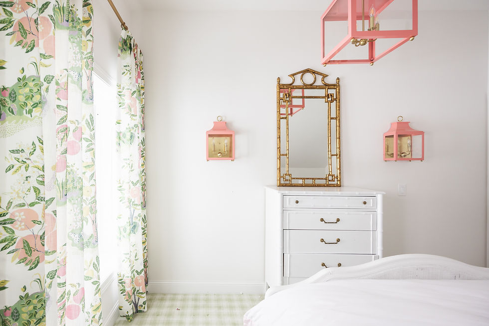 Soft, custom window drapery in a colorful botanical print elevates this bedroom, adding pattern, warmth, and a designer touch alongside layered lighting and classic furnishings.
