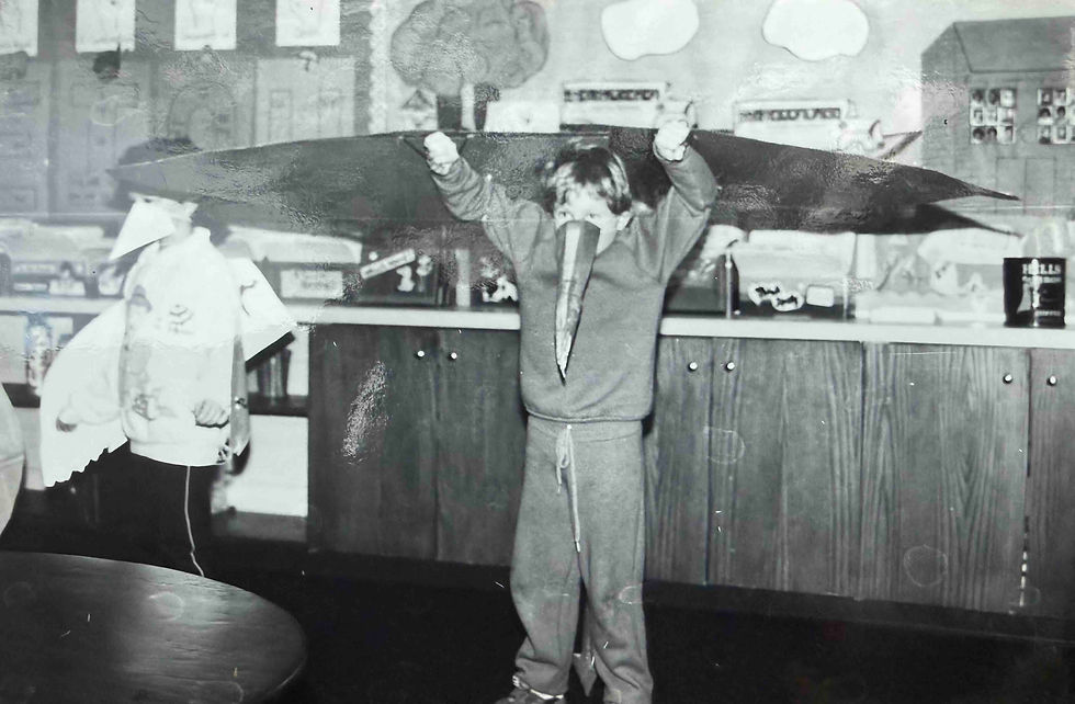 A 9 year old Tres as a pterodactyl at Halloween. Costume made by hand by Mother.