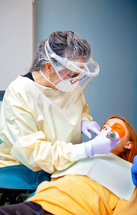 Dr. Alligood carrying out dental work on a child