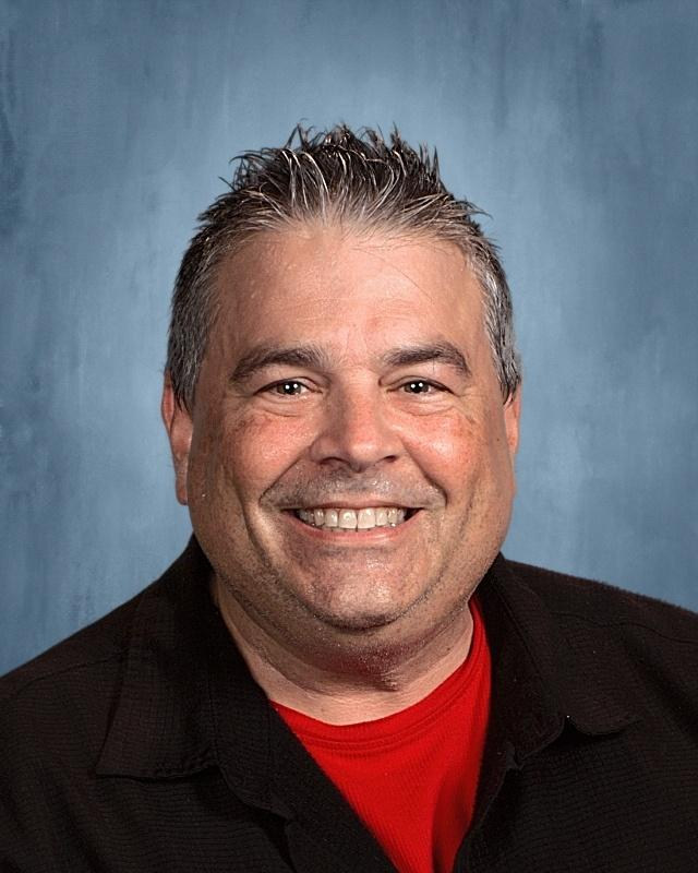 English instructor smiling in a professional headshot.