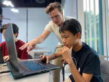 Teacher assisting a student with focused academic work