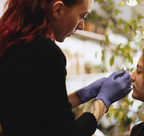 Megan Smith performing a piercing
