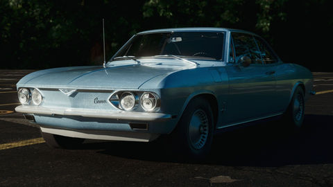 Film-grade CGI vehicle rendering and environment composition featuring a classic car on a asphalt track with realistic depth of field and dramatic morning lighting.