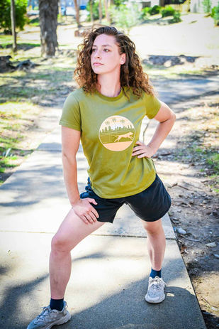 Woman stretching before a jog in a dog mom running shirt