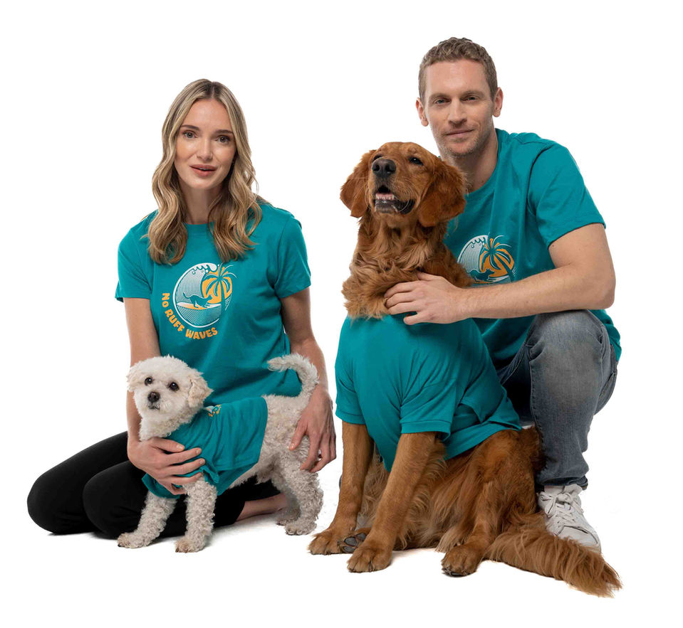 A couple and their dogs wearing organic cotton matching dog and owner shirts