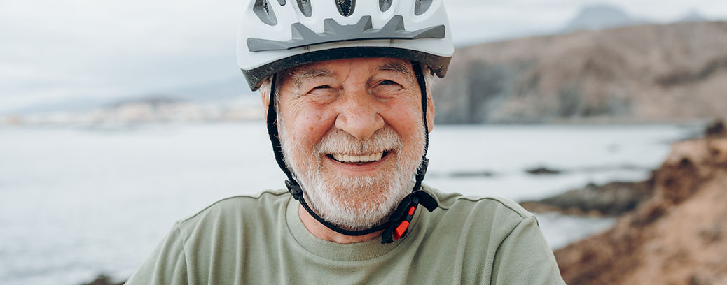 One happy cheerful active senior man looking at the camera smiling and enjoying wearing bi