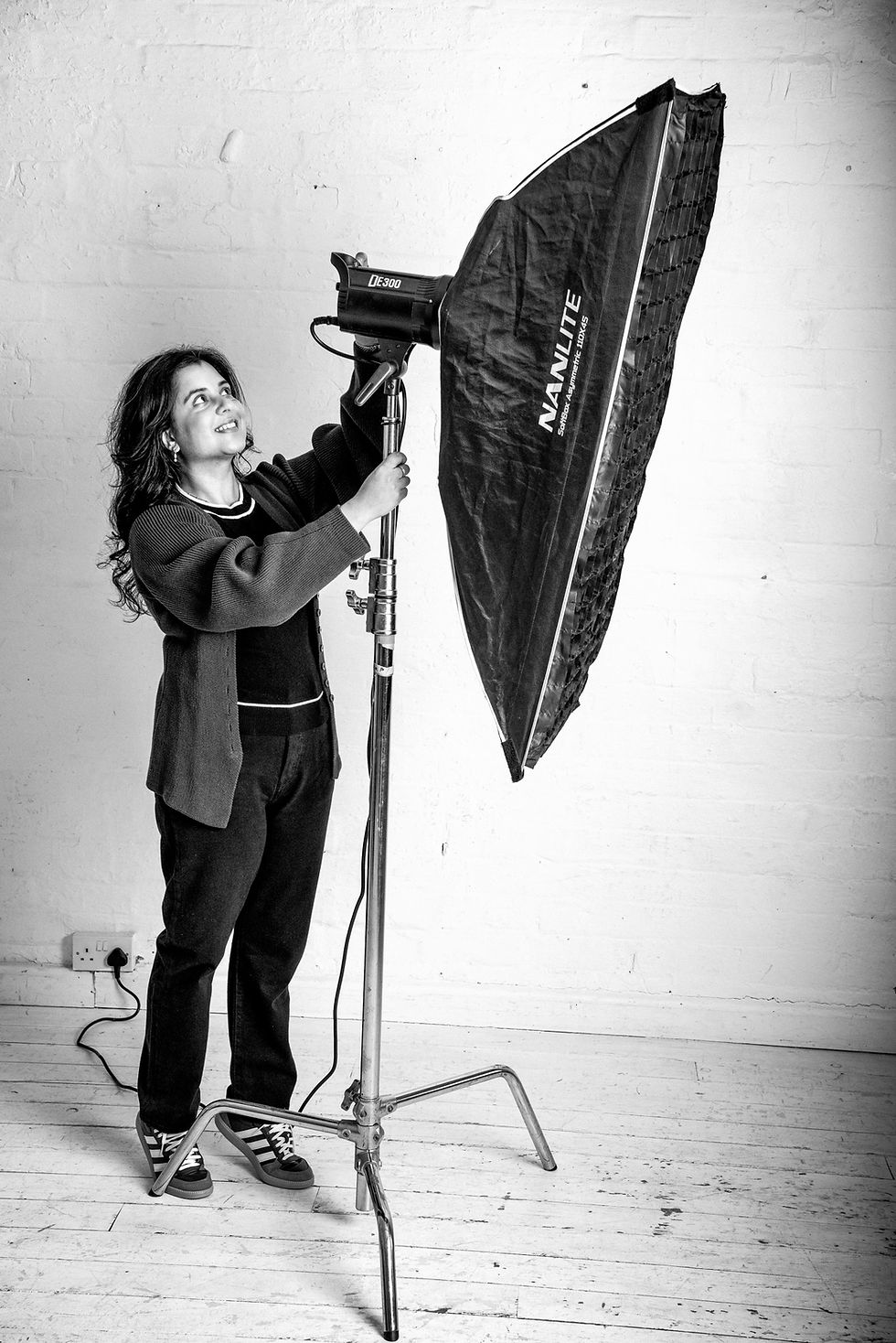 Kelly adjusting a professional lighting stand