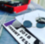 A picture of a 2018 TRNSMT festival record with sunglasses placed on top and a red record player in the background.