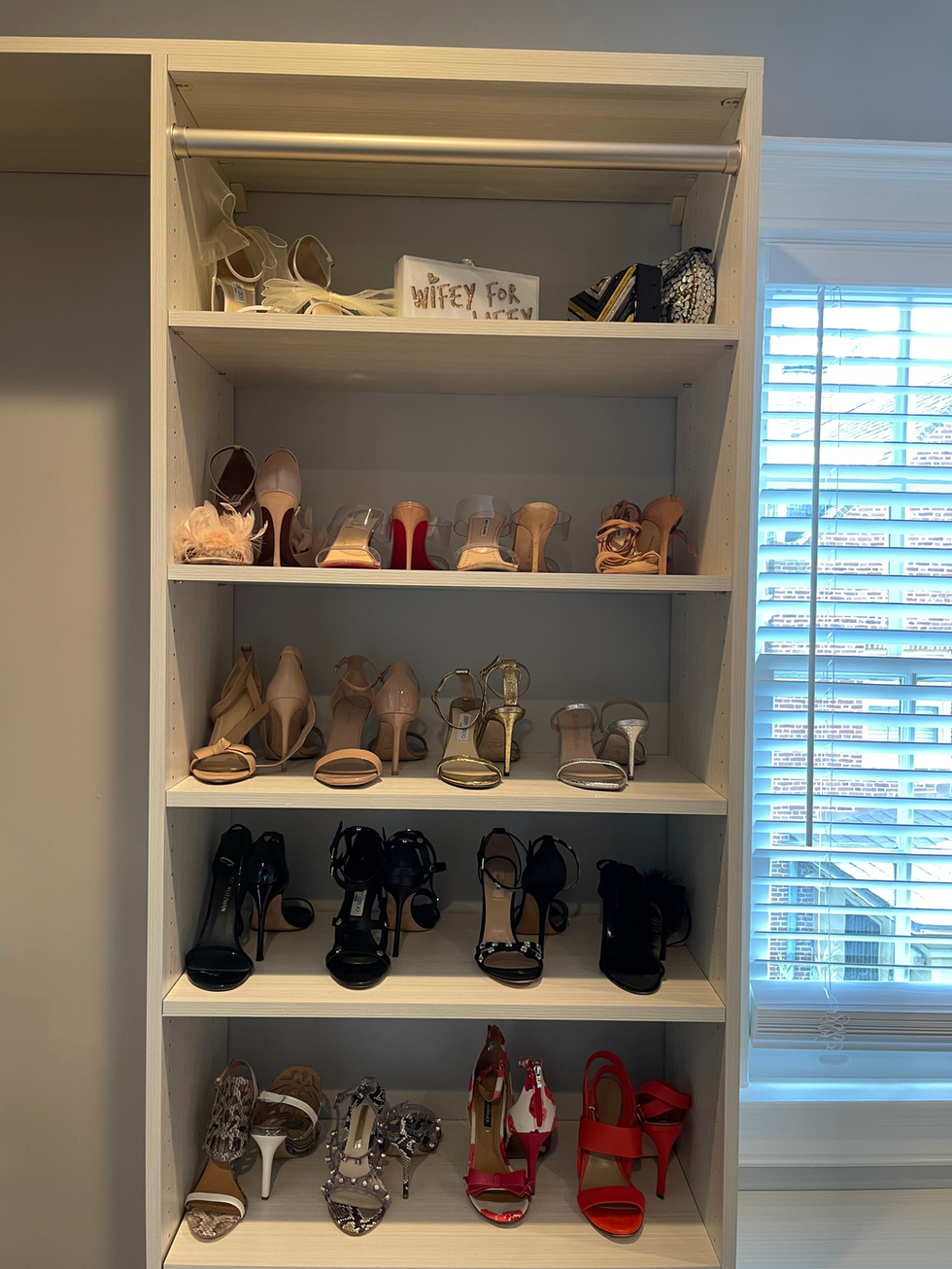 organized shoes in a walk in closet