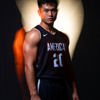 Young athletes in huddle listening to coach before scrimmage