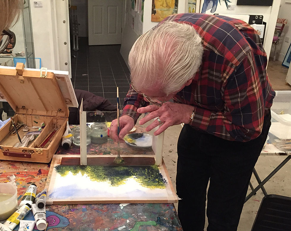 Peter Cunningham painting reflections through glass at ARTBANK Bunclody