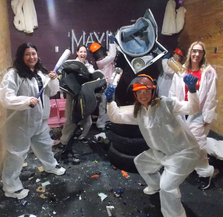 Rage room Birthday Party at Maximum Rage LLC.  Participants posing with tools and breakable items in the rage room. Also know as wreck room, break room, smash room, and rage room.