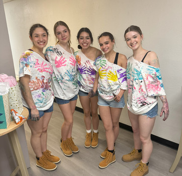Rage n Paint Birthday party participants posing for a photo after a paint session at Maximum Rage Rage Room.