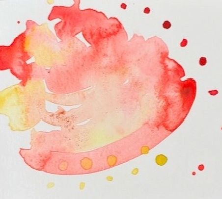 Red and yellow watercolor splash with speckles