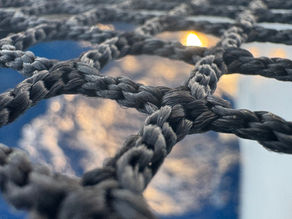 Sonne, die durch das Trampolinnetz von unserem Katamaran Maido durchscheint während unserer Reise zwischen Sardinien und Sizilien