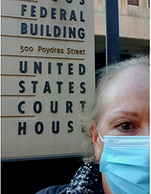 New Orleans courthouse, bald woman, woman in mask