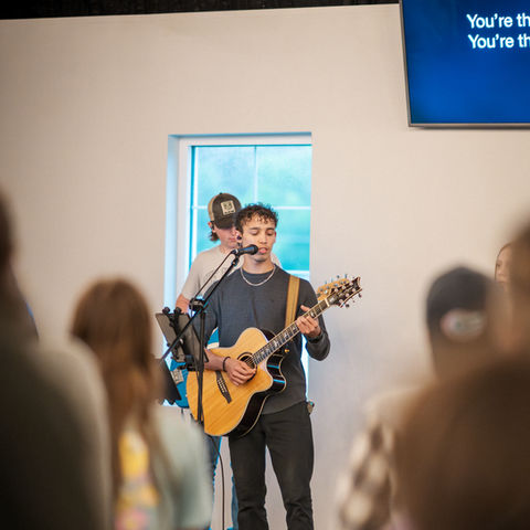 Guitar player leading worship