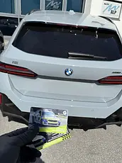 White BMW i5 with Global Telemetrics tracker handover information.