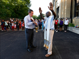 Father George Omwando blessing St. Catherine-St. Lucy School's new playground