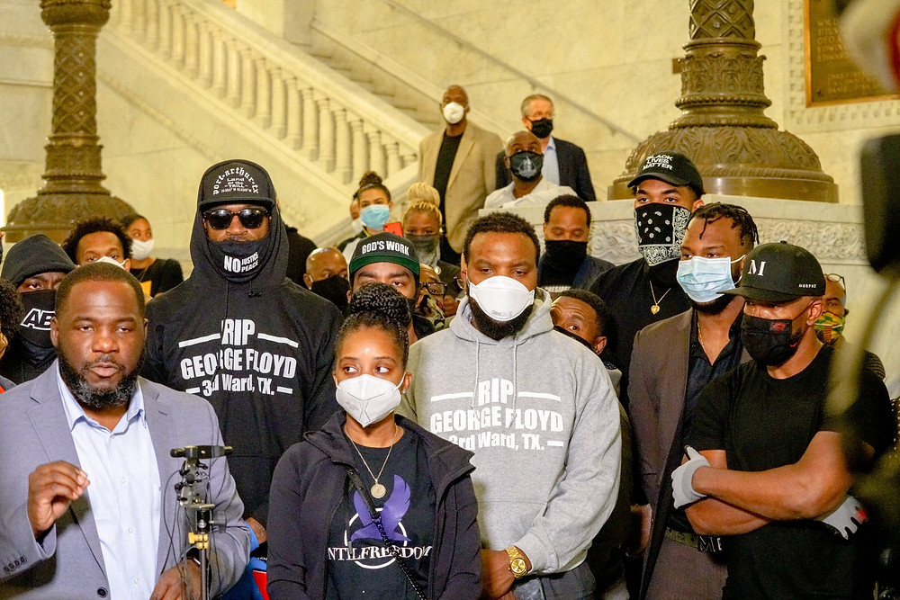 Upon the death of George Floyd, his long-time friend and former NBA player, Stephen Jackson, seen with sunglasses and a black hoodie attends a protest in Minneapolis. He was accompanied by other NBA players and star center, Karl Anthony-Towns (back right). Stephen Jackson also mentioned the bond between him and George Floyd: "Every city, every team I played on everywhere I was, we talked. He was excited with everything I did".
