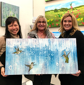 Artist Lucy Liew holding painting Lets Dance with clients.jpg